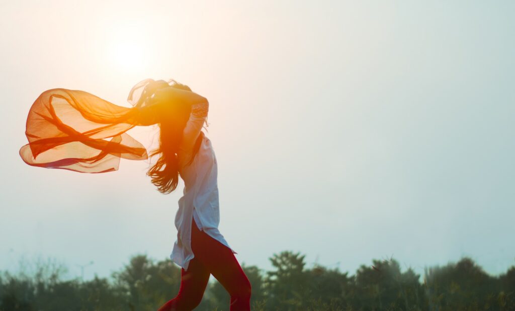 woman spreading hair at during sunset